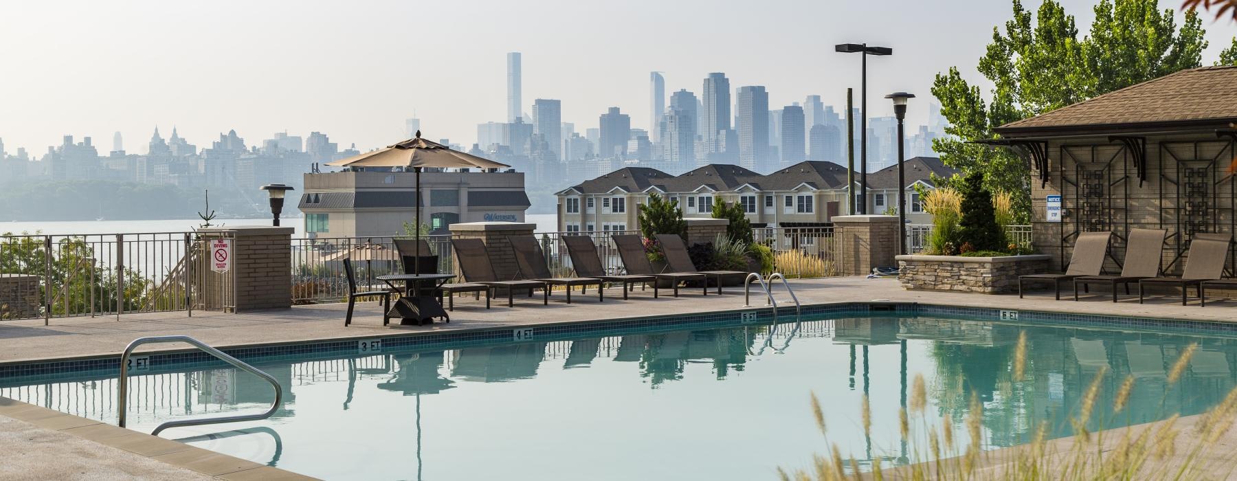 a pool with a city in the background