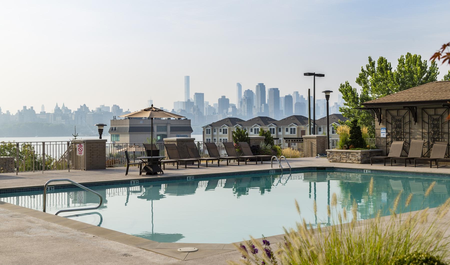 a pool with a city in the background